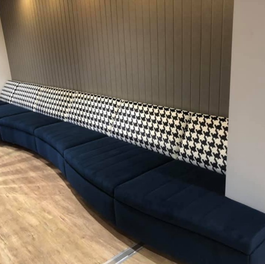 A Fabric Seat Built Into Wall With Black And White Back Rest and Navy Blue Seats — Metreson Upholstery In Unanderra, NSW