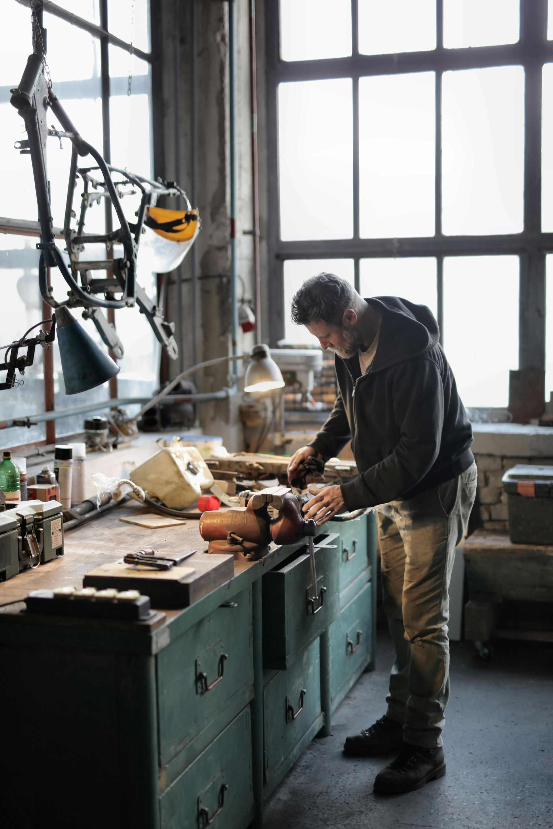 A man is working on a piece of equipment in a workshop.