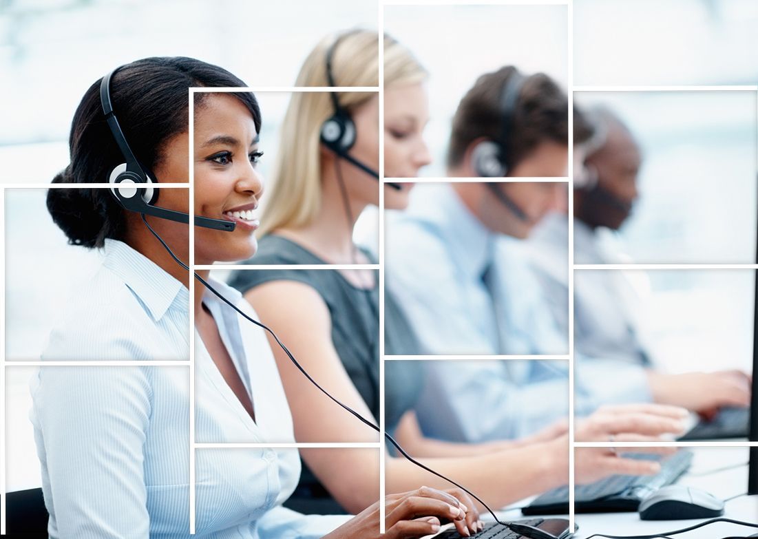 A group of people wearing headsets are working in a call center.