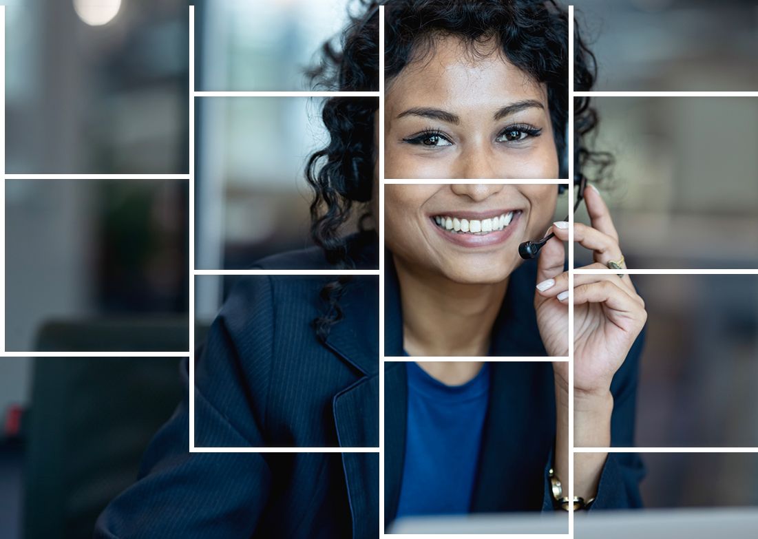 A woman wearing a headset is smiling while talking on a cell phone.