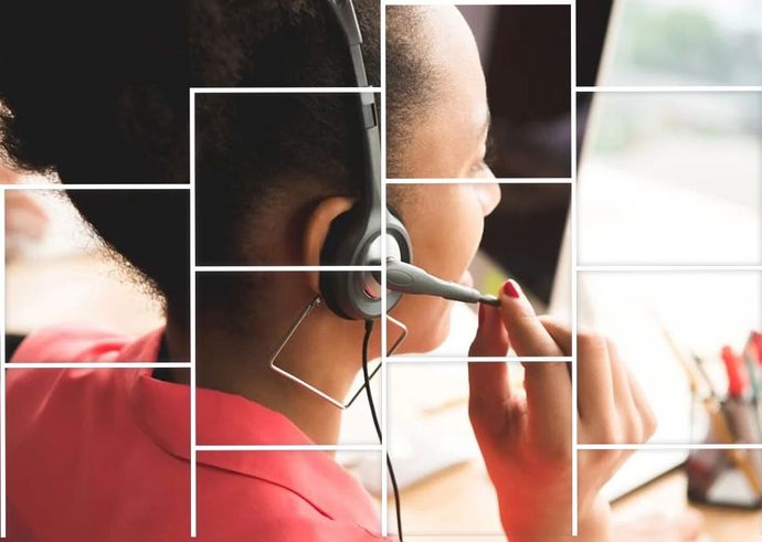 A woman wearing a headset is sitting in front of a computer. A woman wearing a headset is sitting in front of a computer.