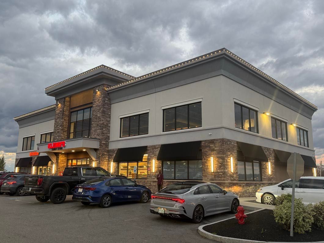 A large building with cars parked in front of it.