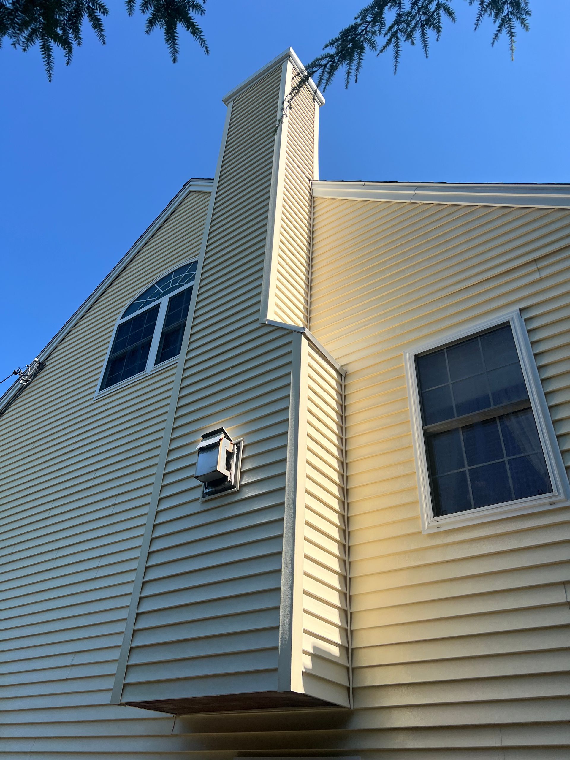 A house with a chimney on the side of it
