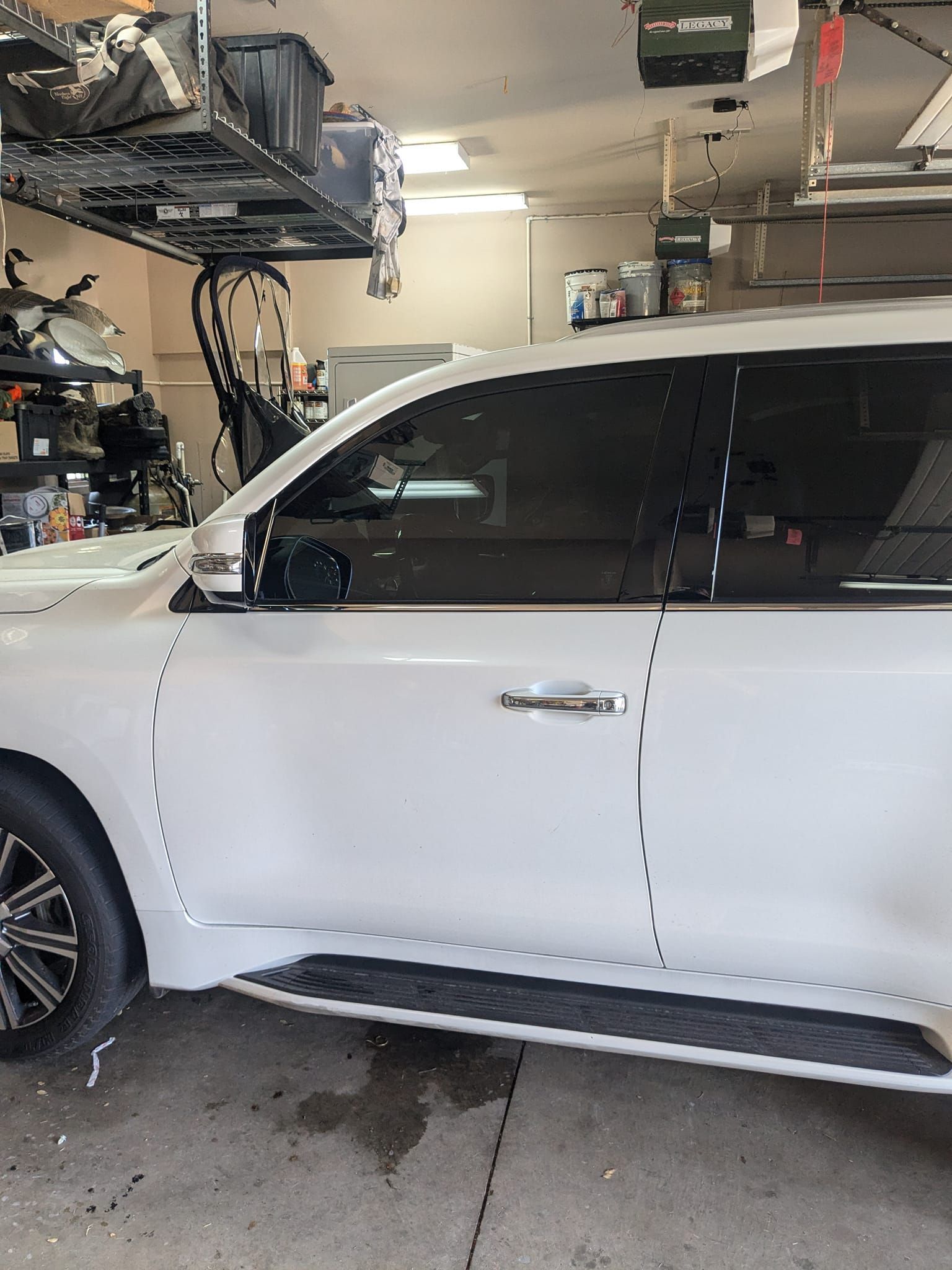 A white suv is parked in a garage.