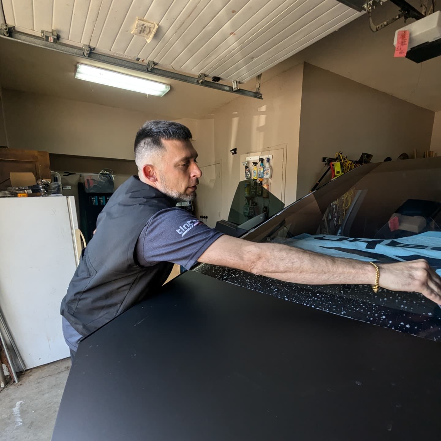 A man is working on a car in a garage.