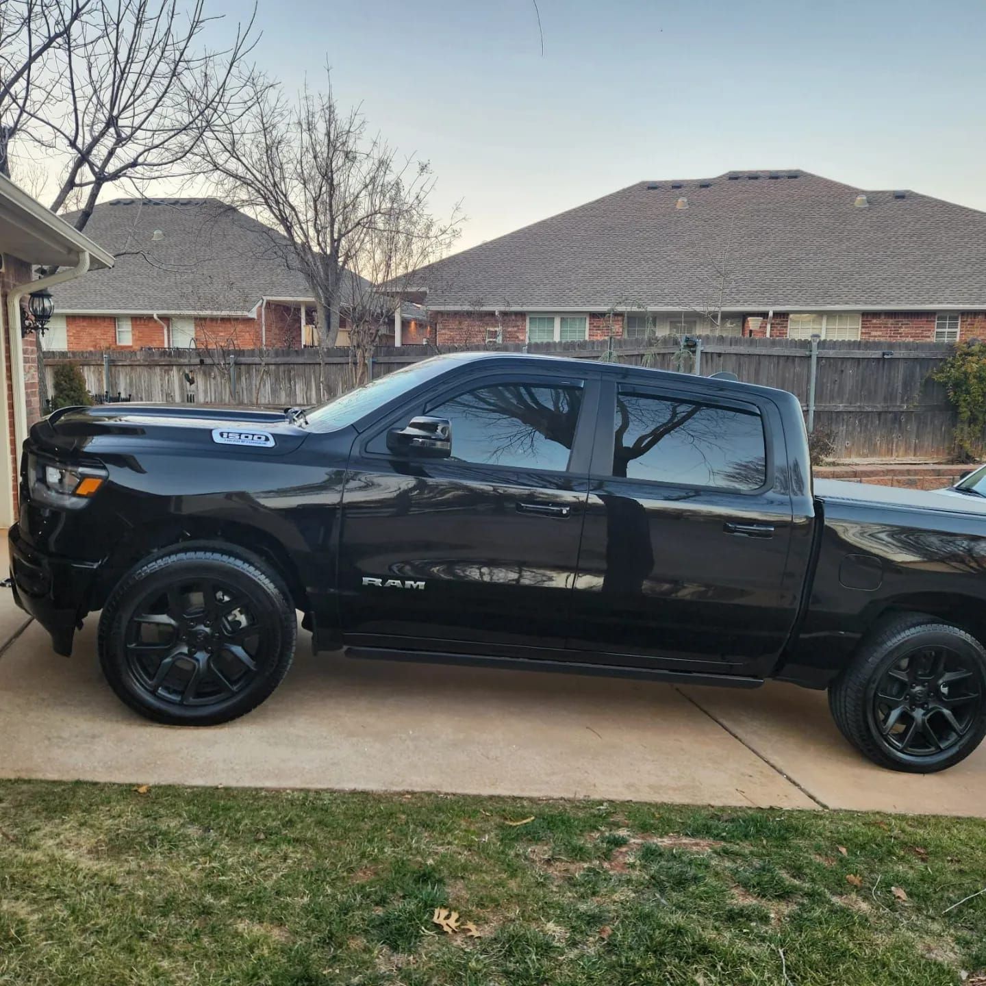 A black truck is parked in front of a house