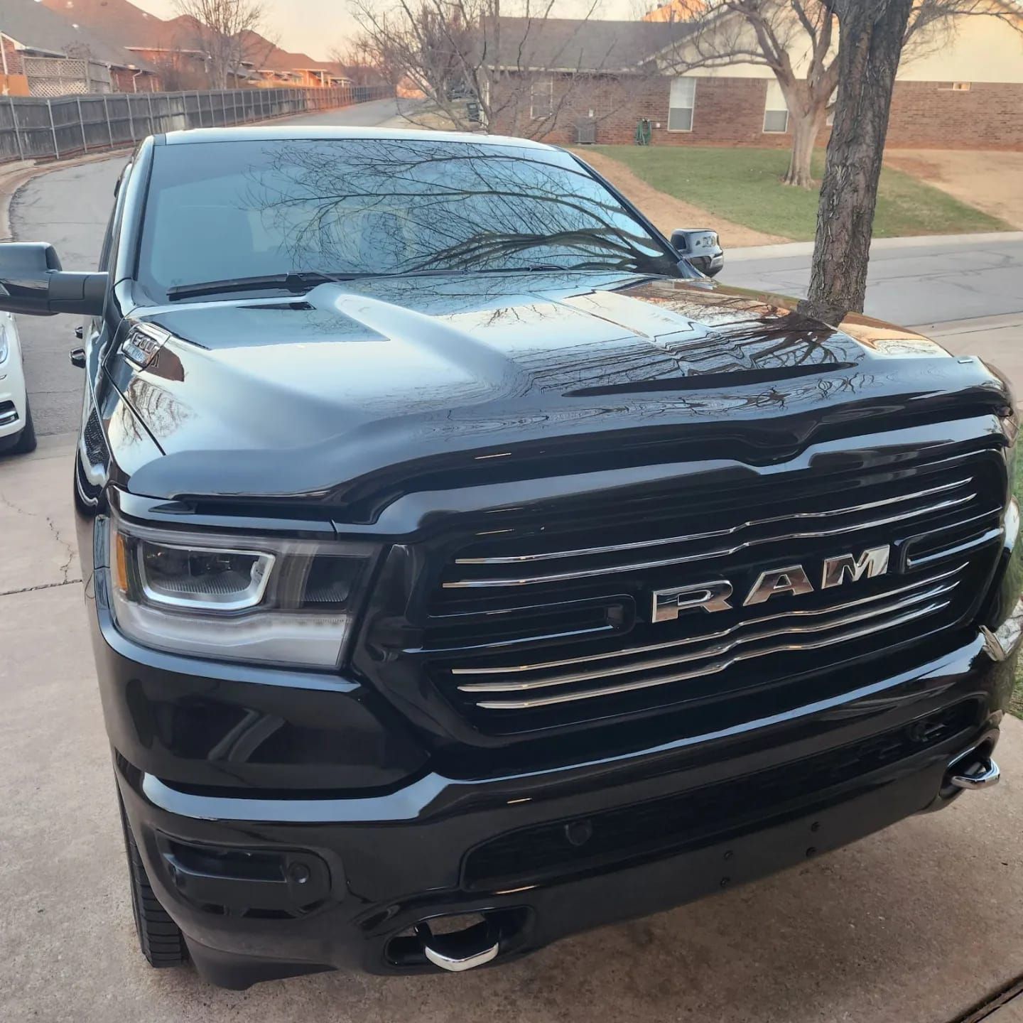 A black ram truck is parked on the side of the road