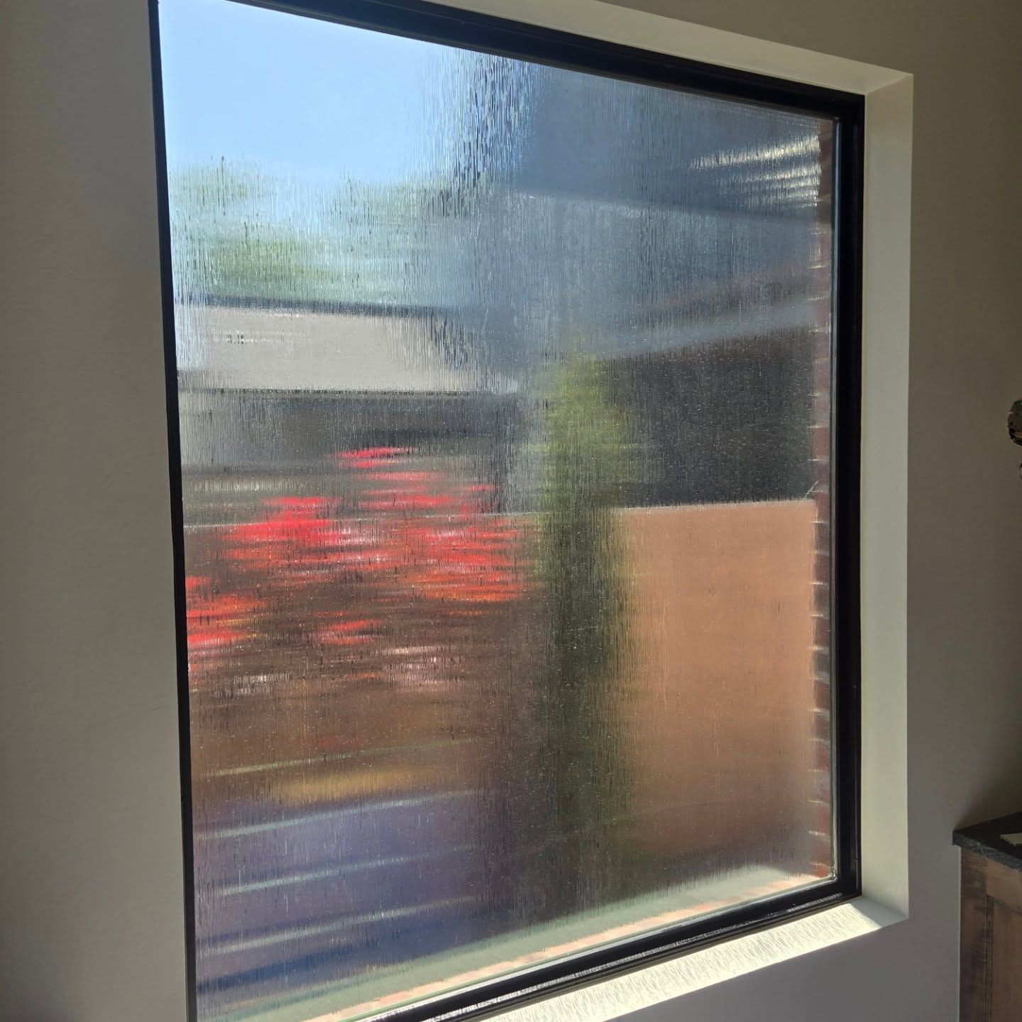 A window with a lot of condensation on it in a room.