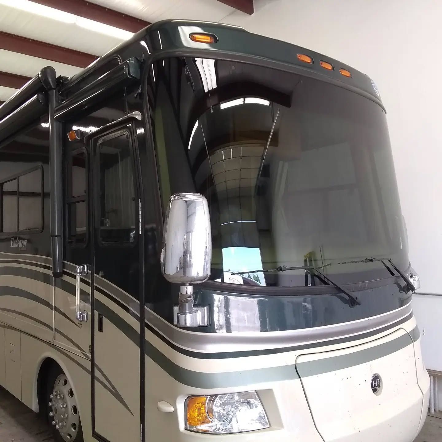 A large rv is parked in a garage
