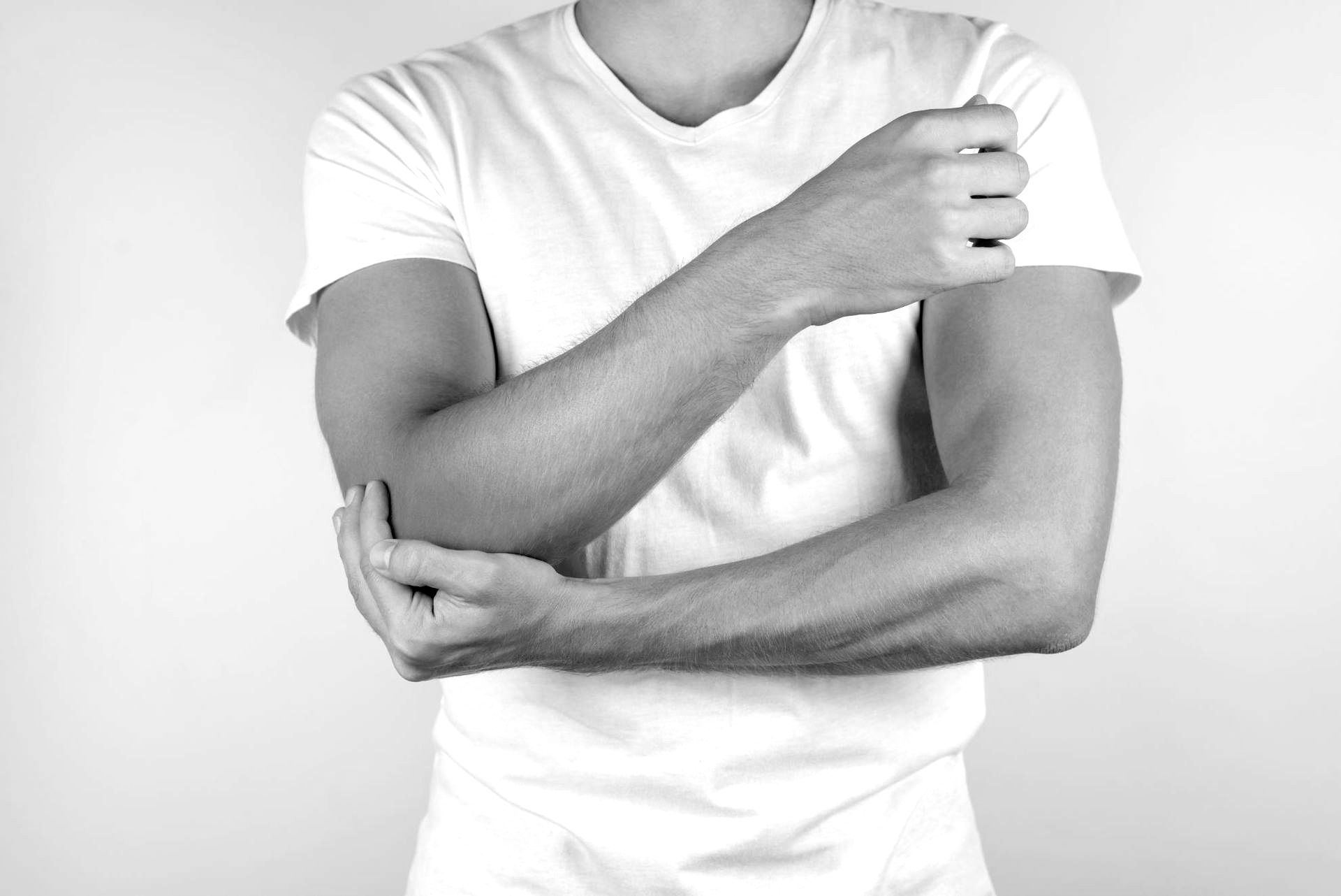 man with cubital tunnel syndrome holding painful elbow