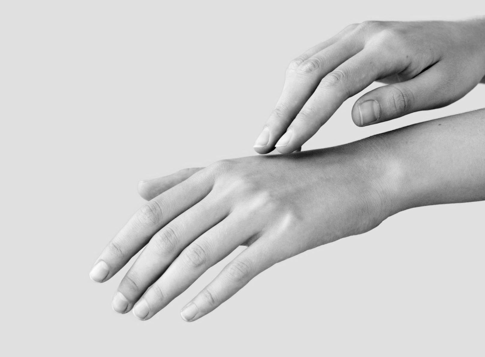 black and white closeup photo of youthful hands after fat grafting procedure