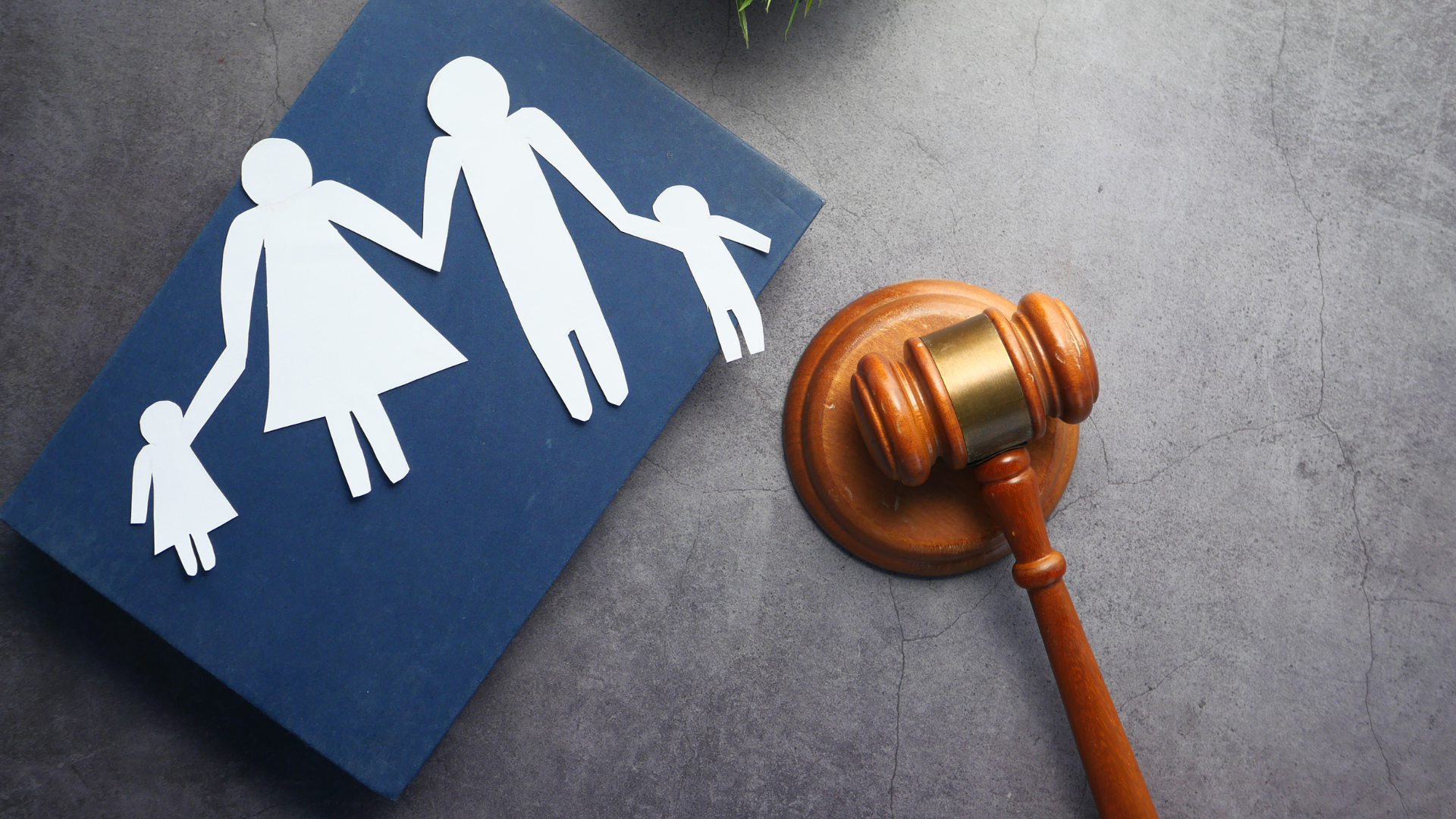 A family cutout on a blue book next to a wooden gavel.