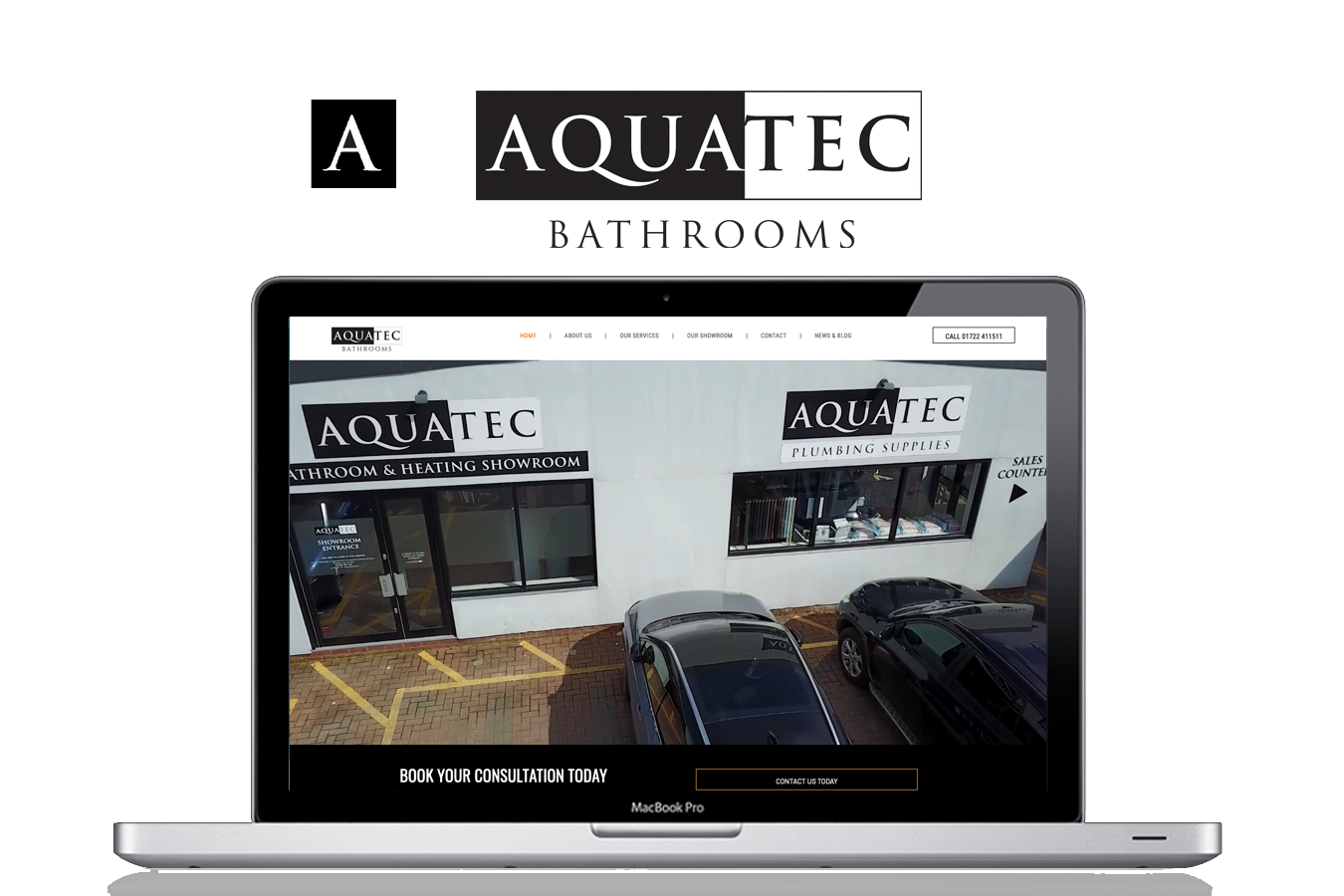 A laptop computer is open to a website for aquatec bathrooms.