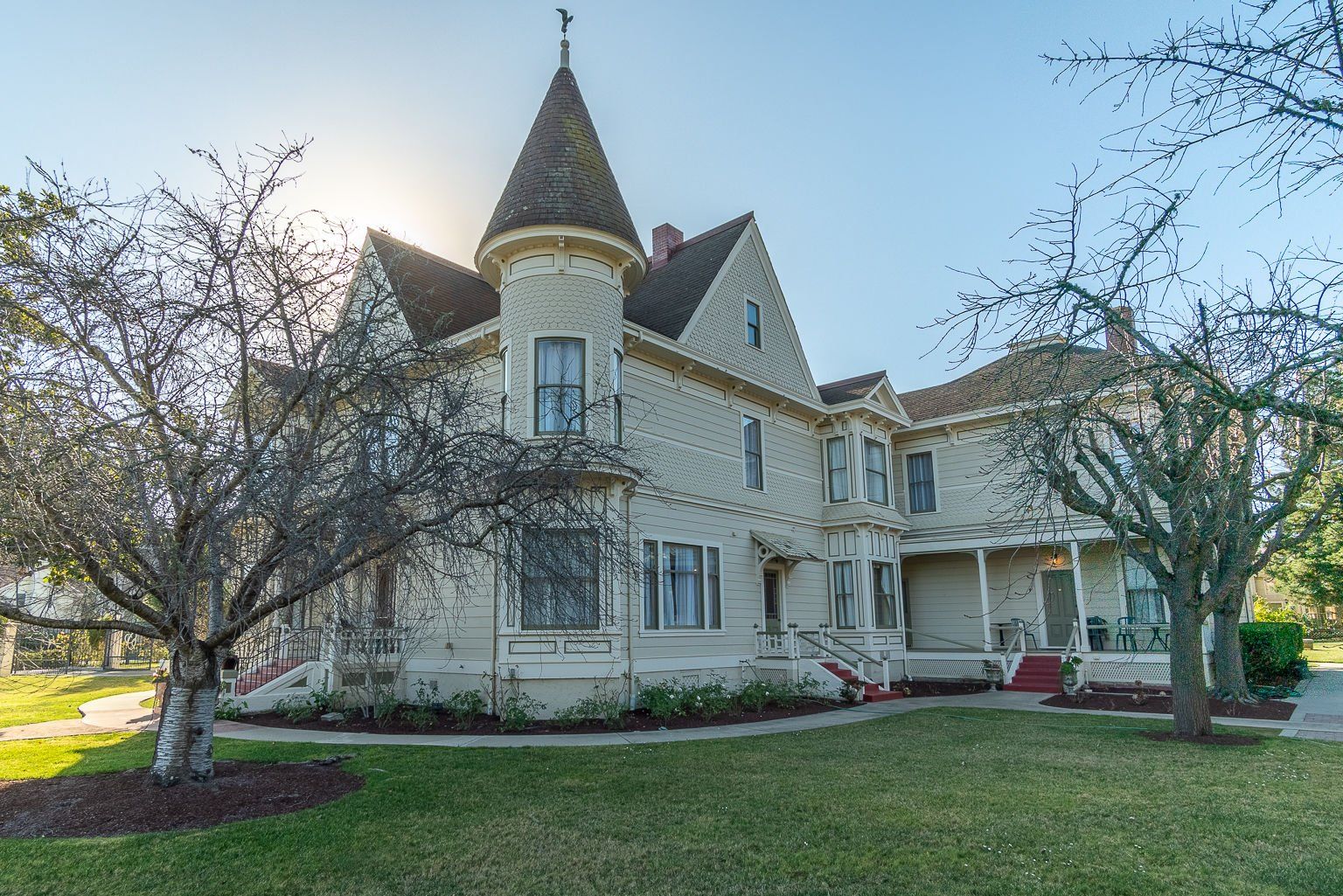 A large white house with a tower on top of it.
