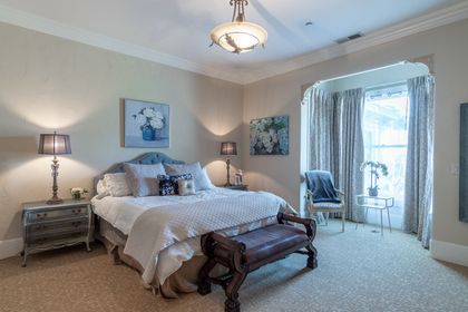 Chateau Coralini guest suite with Victorian furnishings and cozy bedding near Monterey.