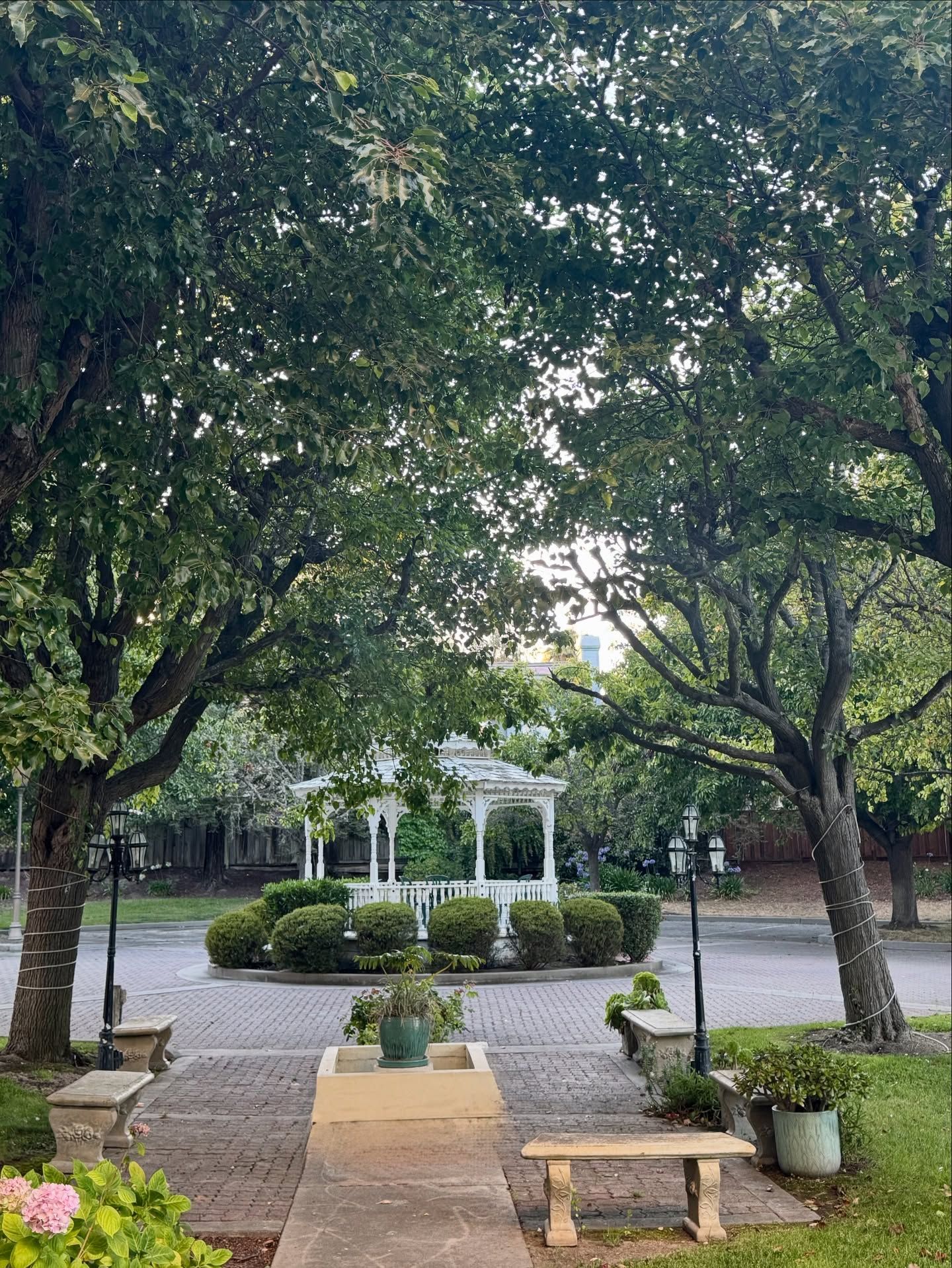 Courtyard garden at Chateau Coralini with manicured greenery and heritage details.