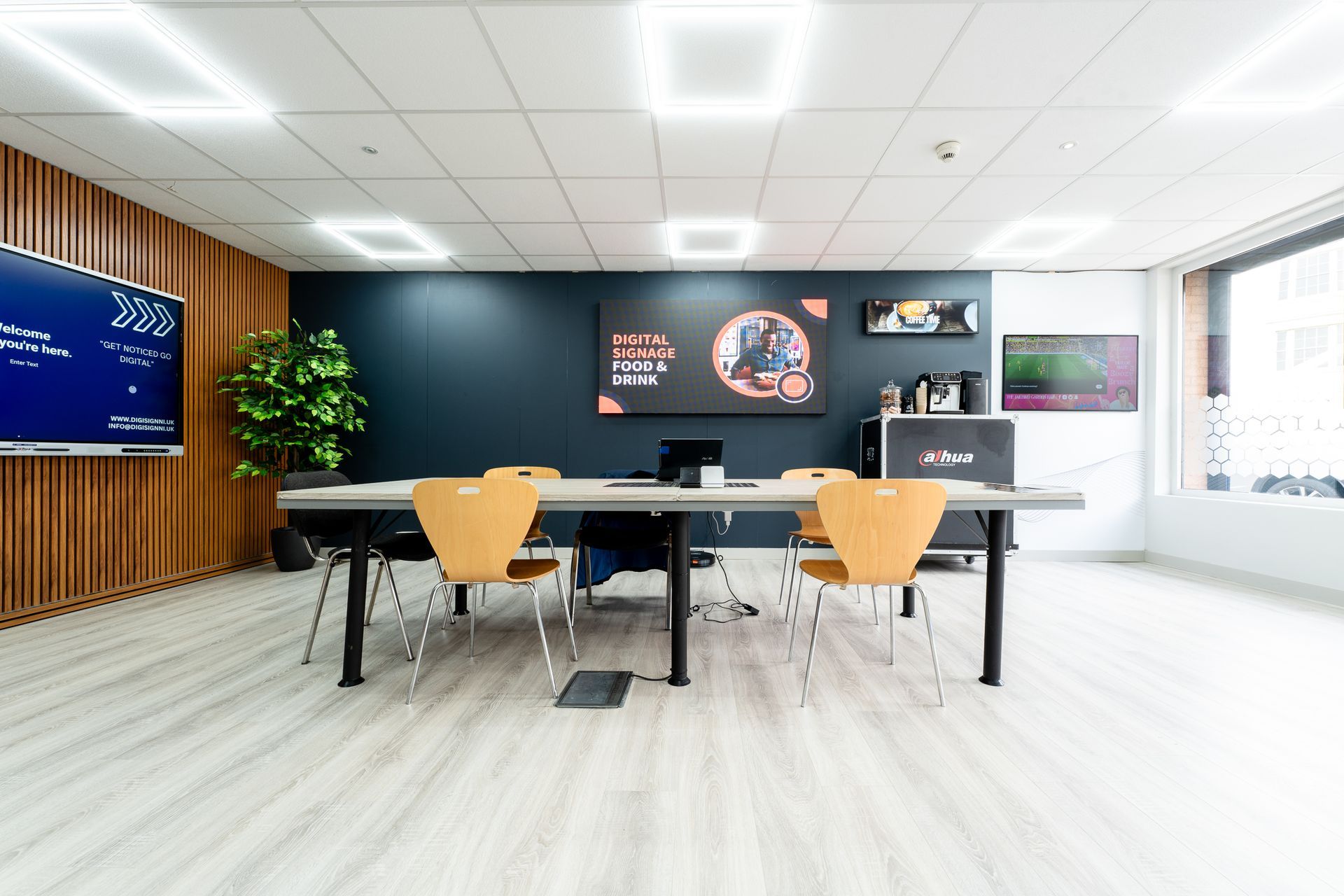 A conference room with a long table and chairs.