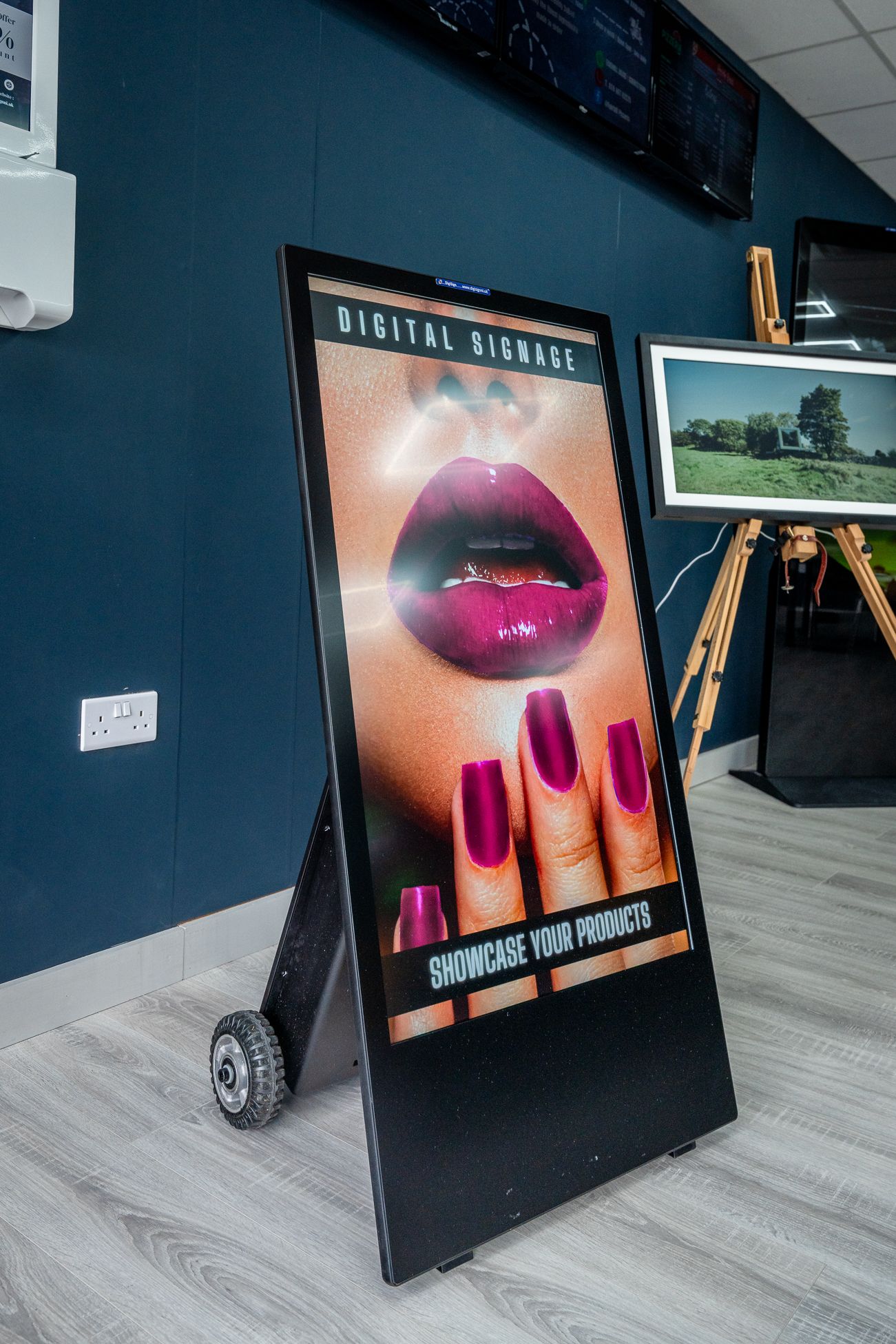 A sign with a picture of a woman 's lips and nails on it