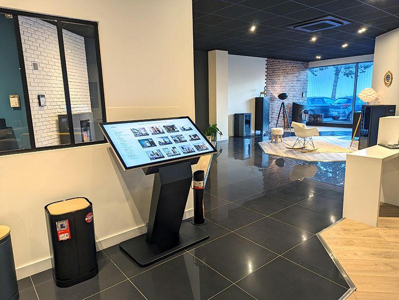 A large flat screen tv is sitting in the middle of a room.