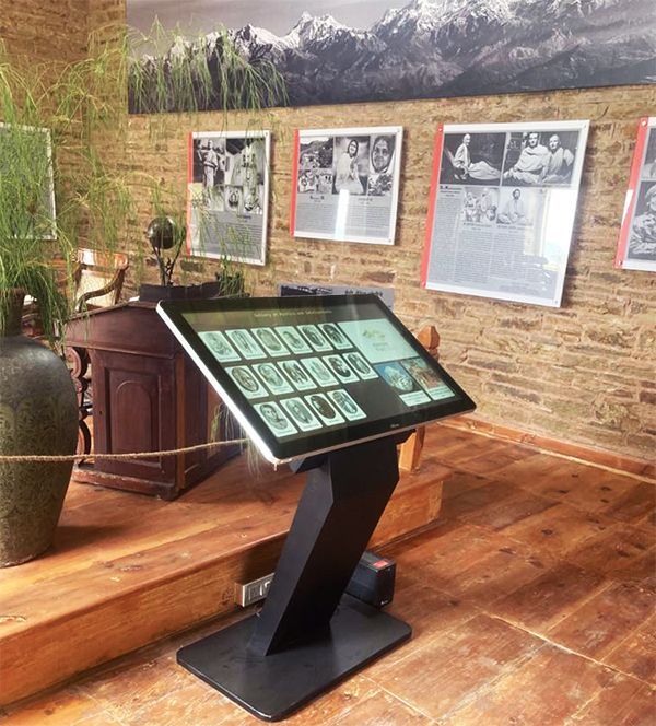 A room with pictures on the wall and a touchscreen