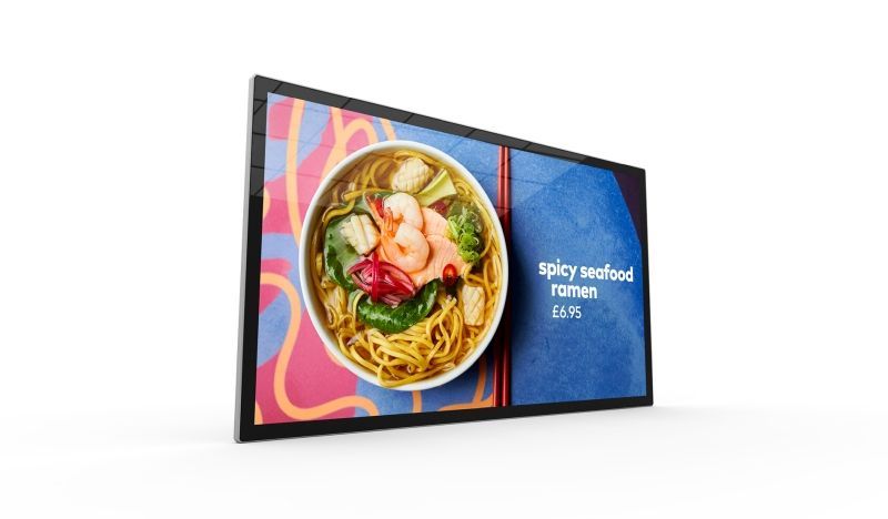 A large flat screen tv with a picture of a bowl of soup on it.