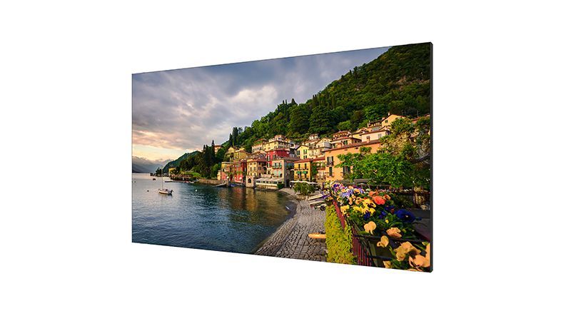 A large painting of a village on the shore of a lake.