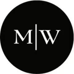 A white letter M and a letter W, separated by a vertical line, centered within a black circle.