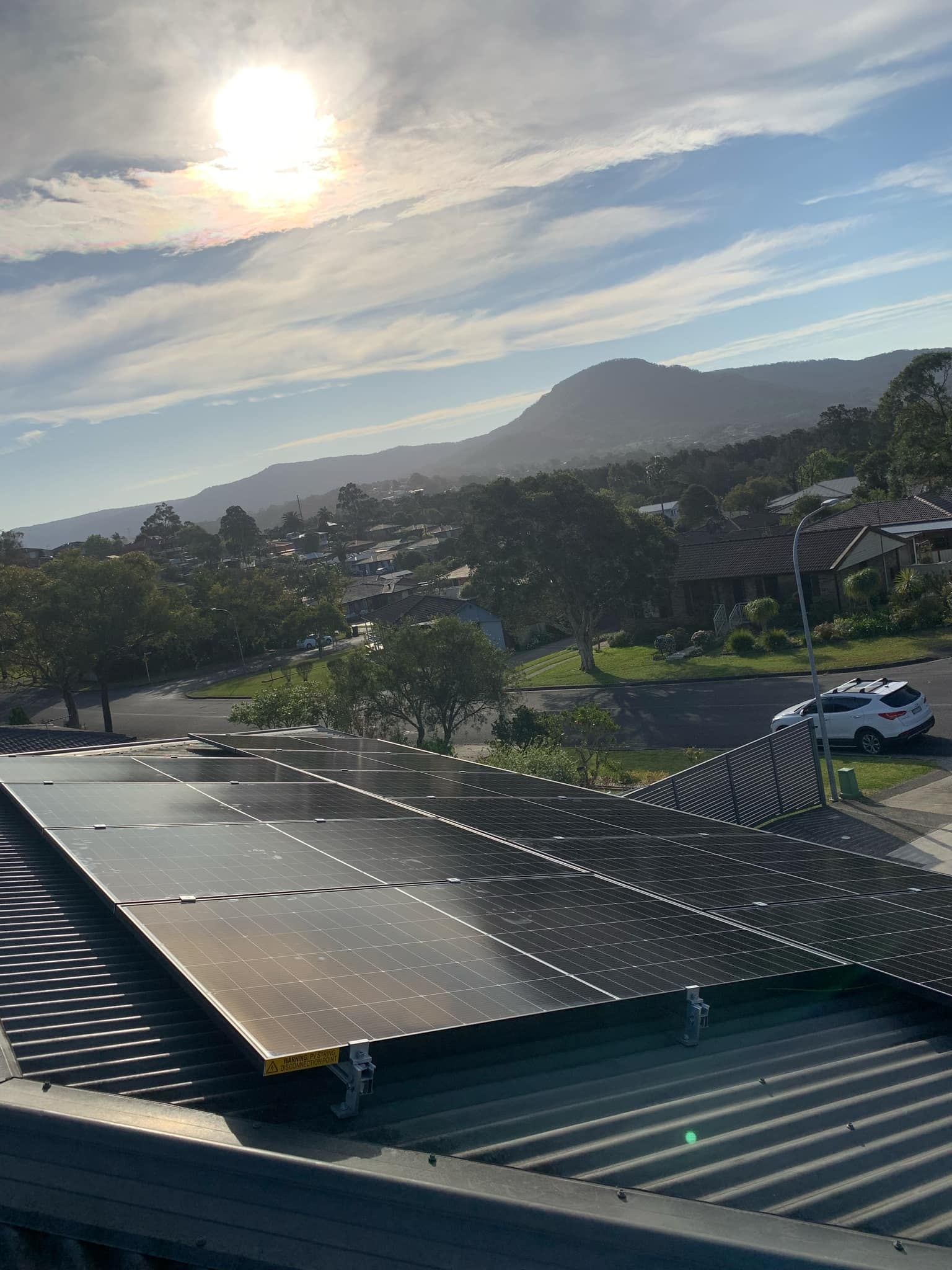 Solar Panels on a Rooftop Overlooking a Coastal Valley — Rapidcool Air Conditioning, Electrical & Solar In Kiama, NSW