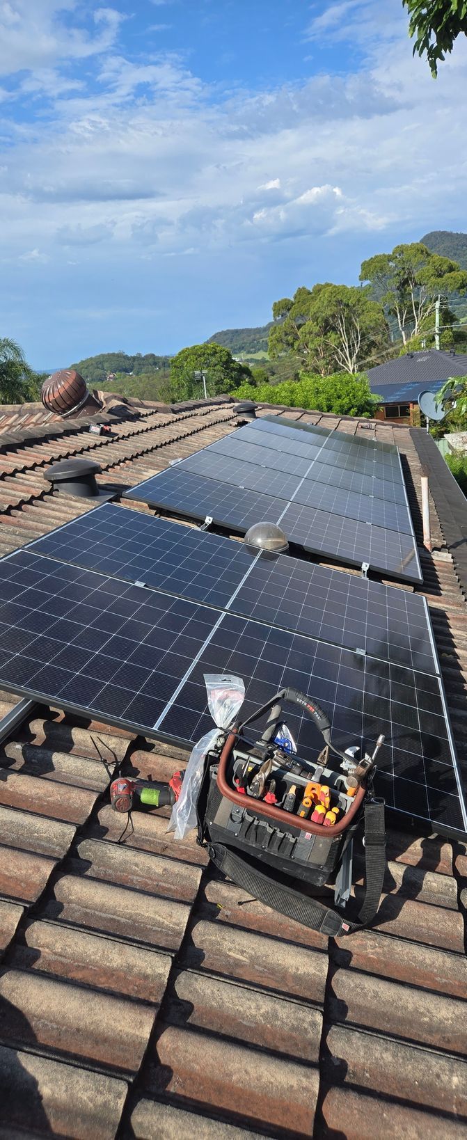 Solar Panels Mounted on a Tiled Rooftop — Rapidcool Air Conditioning, Electrical & Solar In Albion Park, NSW
