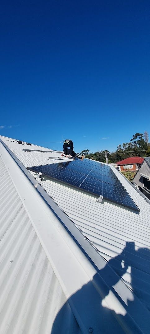 Solar Panels on a White Metal Roof — Rapidcool Air Conditioning & Electrical In Dapto, NSW
