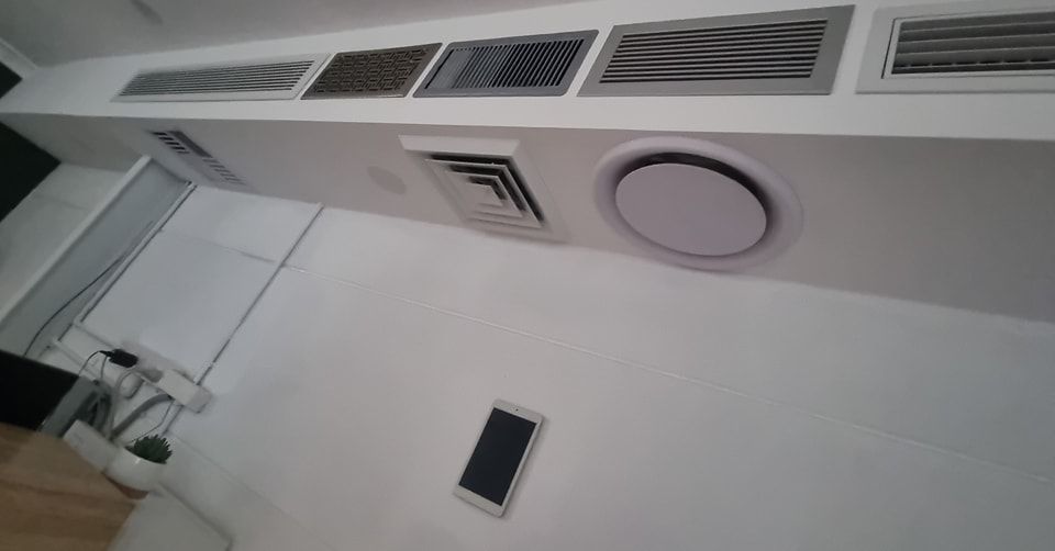 A Room With Air Conditioning Vents On The Ceiling — Rapidcool Air Conditioning & Electrical In Fairy Meadow, NSW