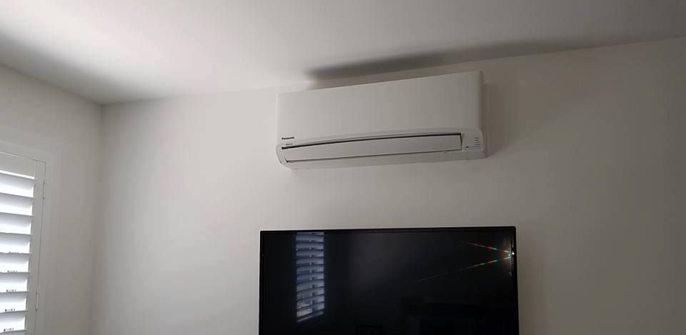A Room With A Television And A Air Conditioner On The Wall — Rapidcool Air Conditioning, Electrical & Solar In Albion Park, NSW