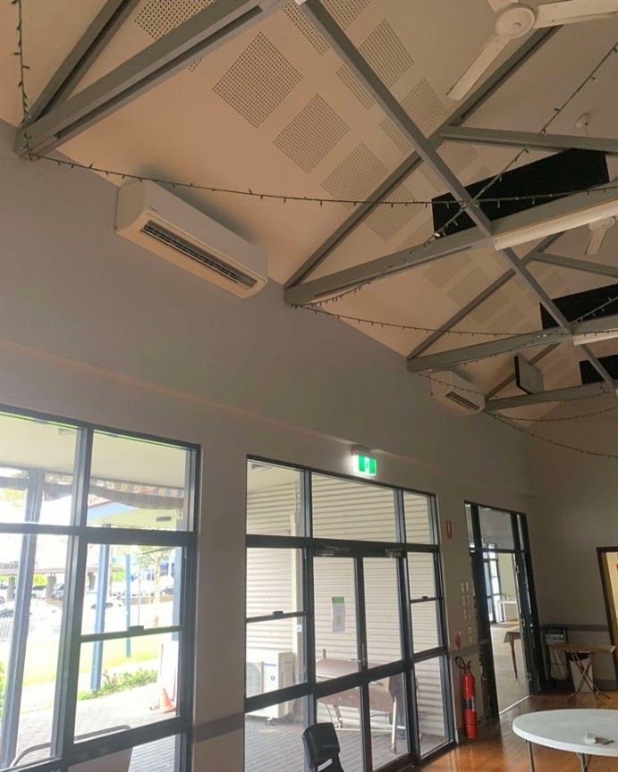 A Room With A Lot Of Windows And An Air Conditioner — Rapidcool Air Conditioning & Electrical In Dapto, NSW