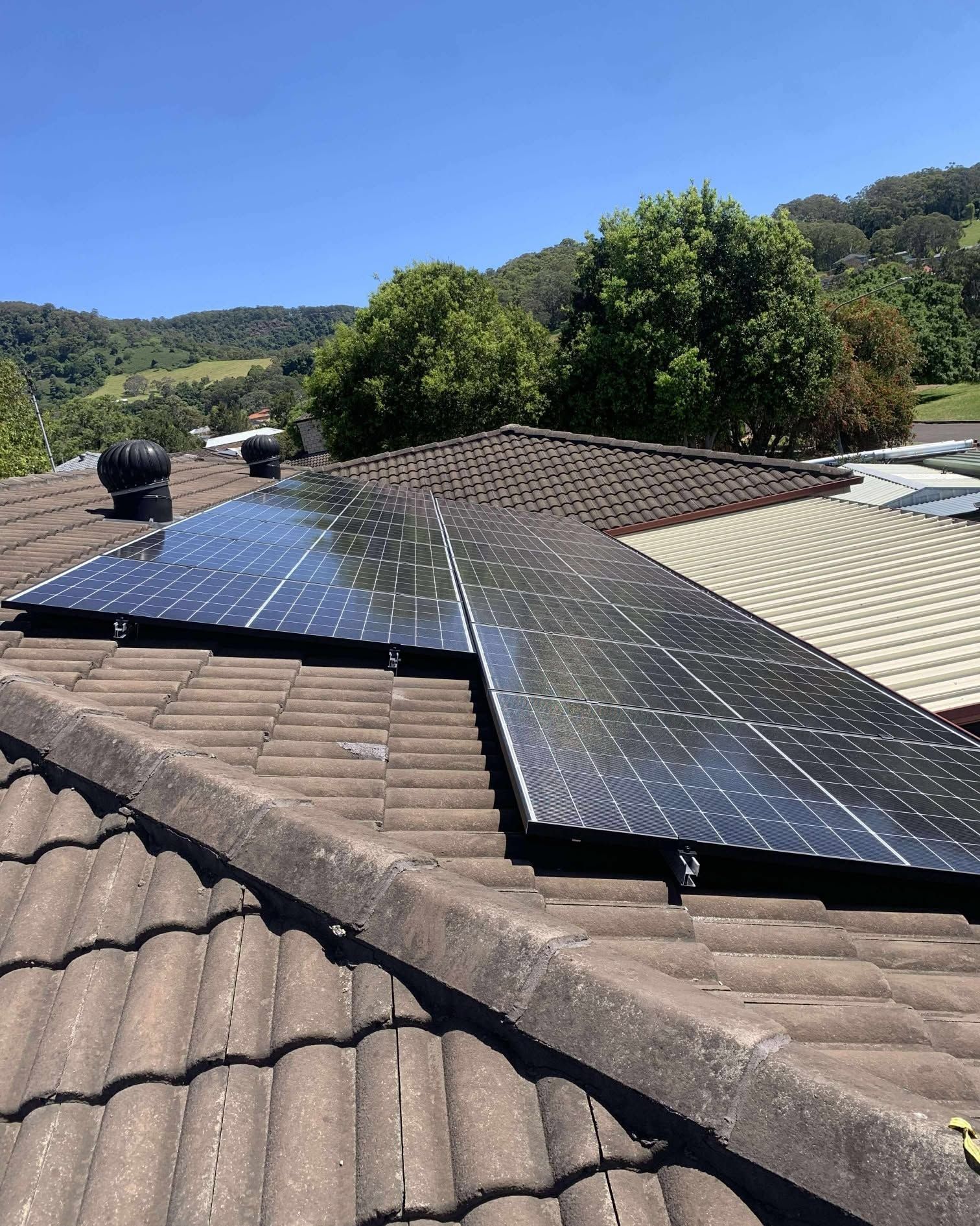 Solar Panels Mounted on a Tiled Rooftop — Rapidcool Air Conditioning & Electrical In Unanderra, NSW