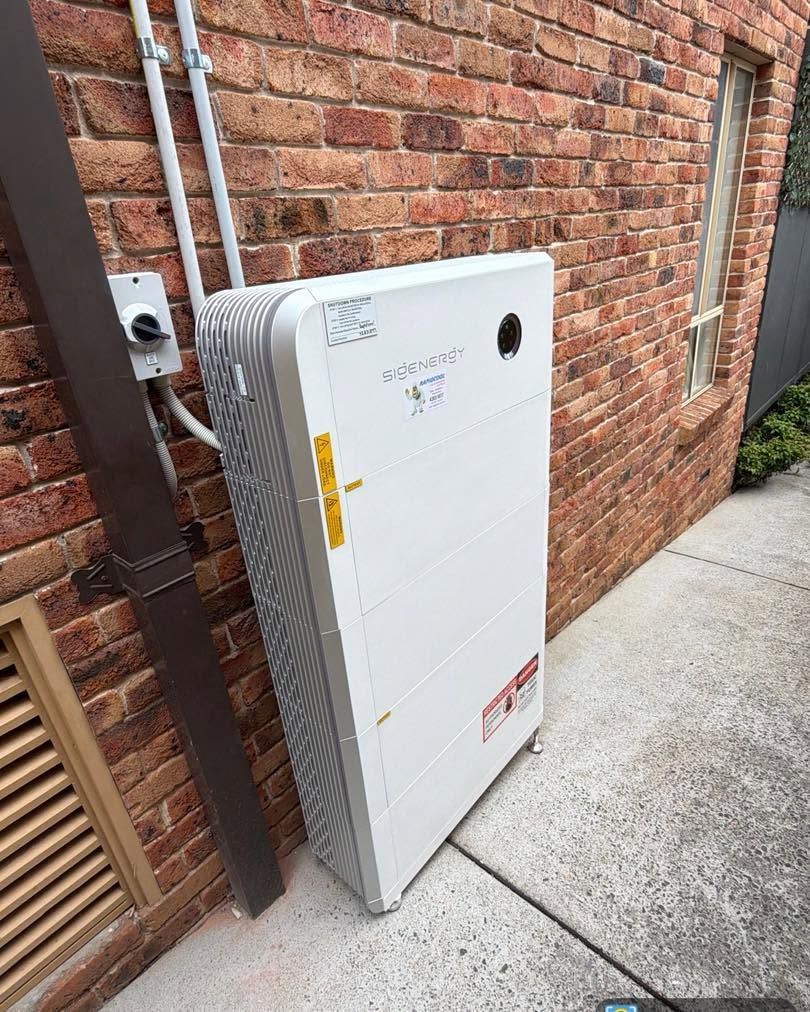 Solar Panels on a Red-tiled Rooftop Under a Clear Blue Sky — Rapidcool Air Conditioning, Electrical & Solar In Dapto, NSW