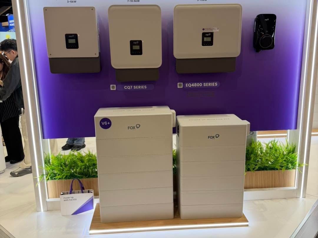 White Solar Battery Display Booth With Small Plants and a Wooden Counter — Rapidcool Air Conditioning, Electrical & Solar In Illawarra, VIC