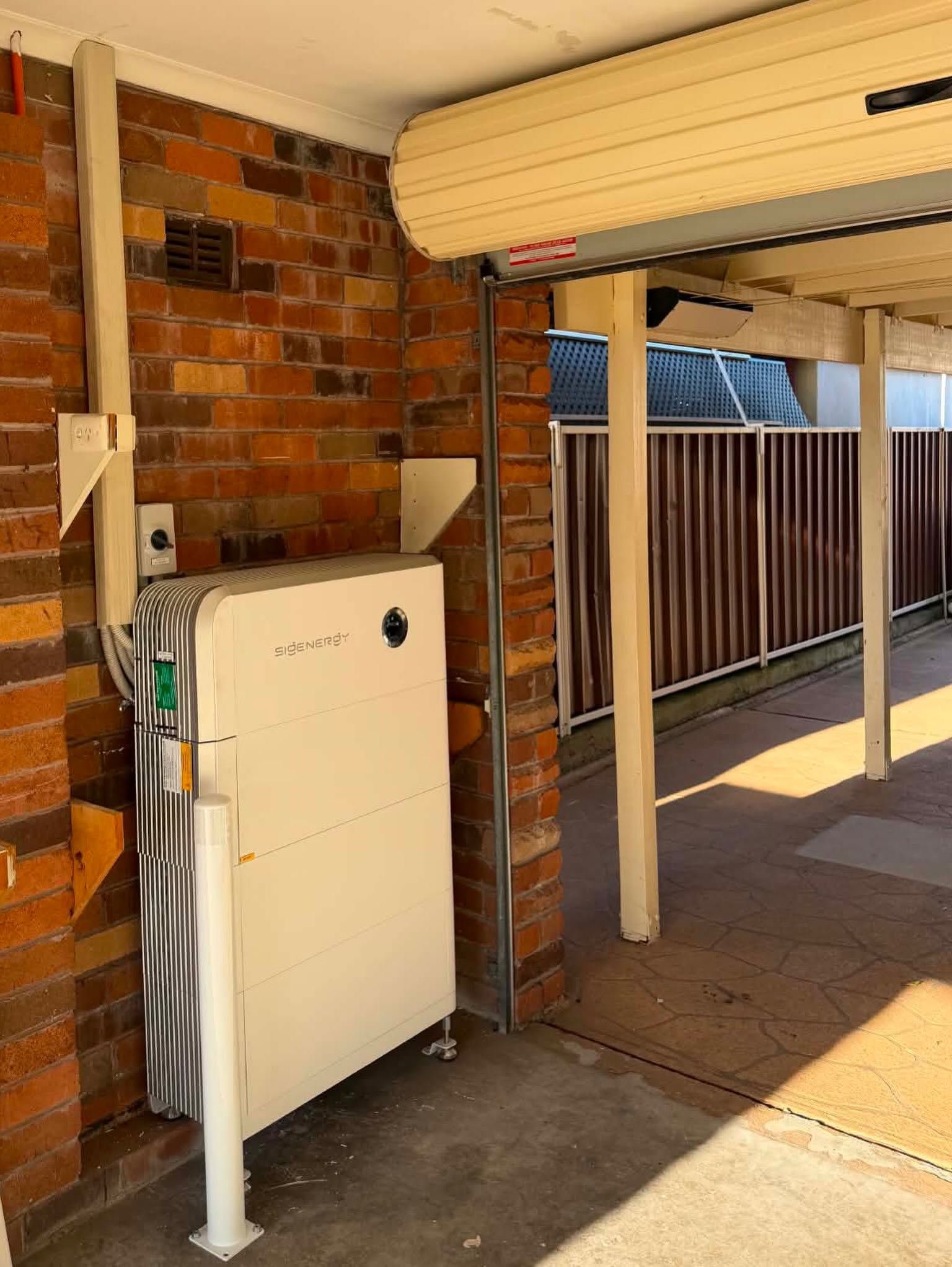 Outdoor Air Conditioner Unit Beside a Brick Wall — Rapidcool Air Conditioning, Electrical & Solar In Illawarra, VIC