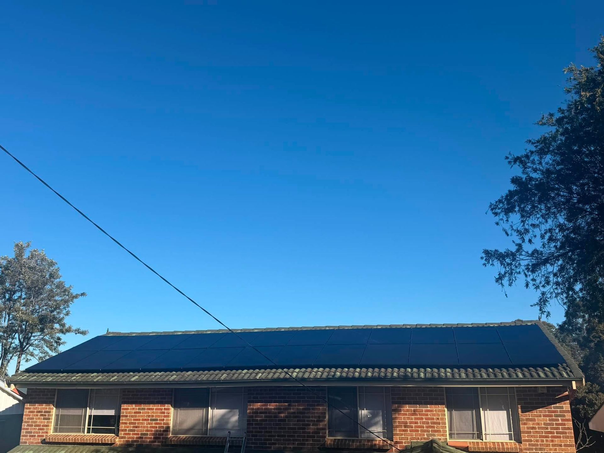 Single-story Brick House With a Dark Roof — Rapidcool Air Conditioning & Electrical In Dapto, NSW