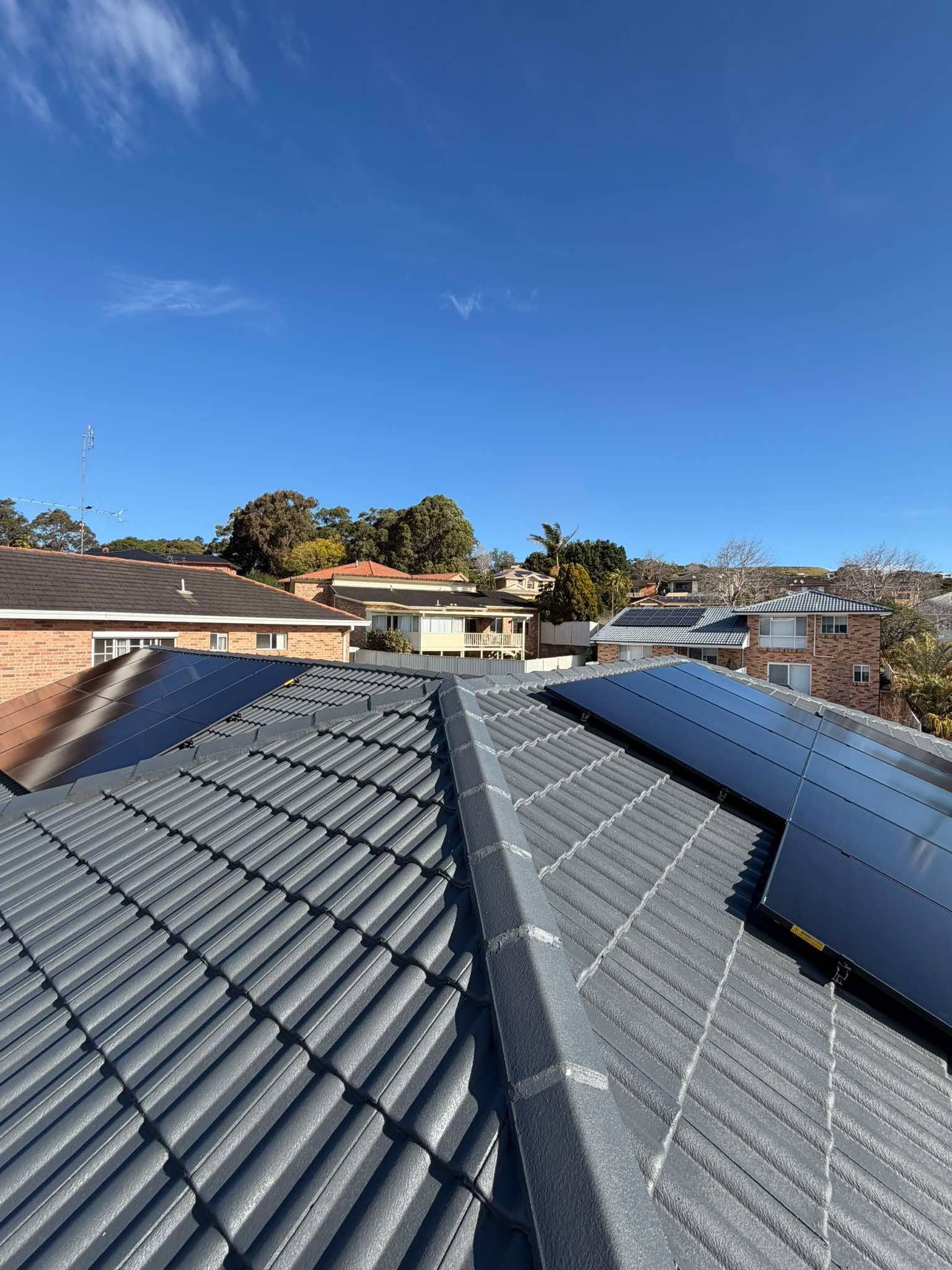 Rooftop View of Tile Roofs Under a Blue Sky — Rapidcool Air Conditioning & Electrical In Dapto, NSW