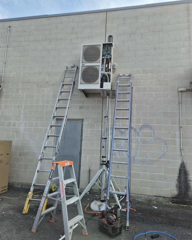 Rapidcool Technician Installing a Commercial Air Conditioning Unit — Rapidcool Air Conditioning, Electrical & Solar In Dapto, NSW
