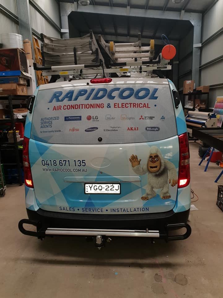 Blue Rapidcool Service Van Parked in a Workshop — Rapidcool Air Conditioning & Electrical In Illawarra, NSW