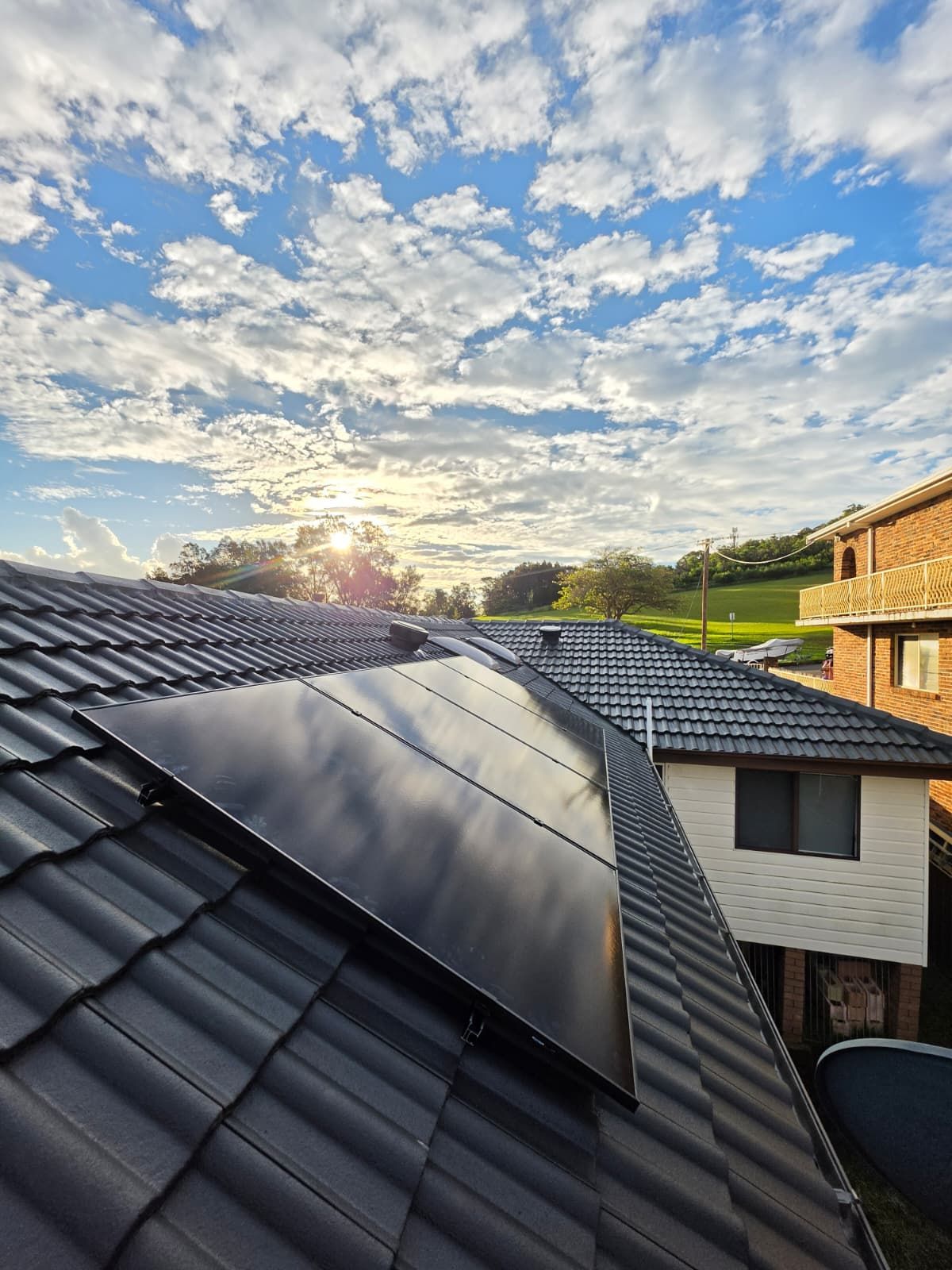 Rooftop Solar Panels on Dark Tiled Roof — Rapidcool Air Conditioning & Electrical In Dapto, NSW