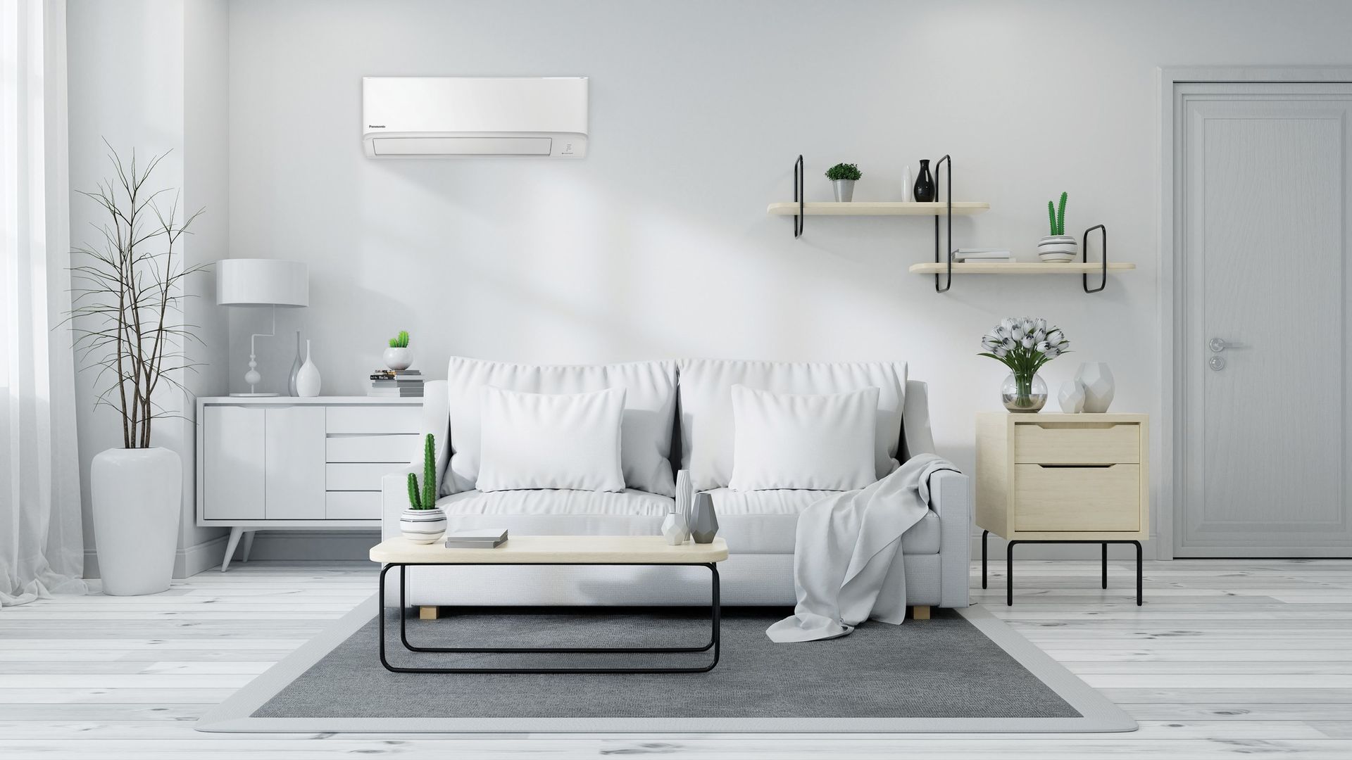 A sleek white modern living room with a white sofa, side tables