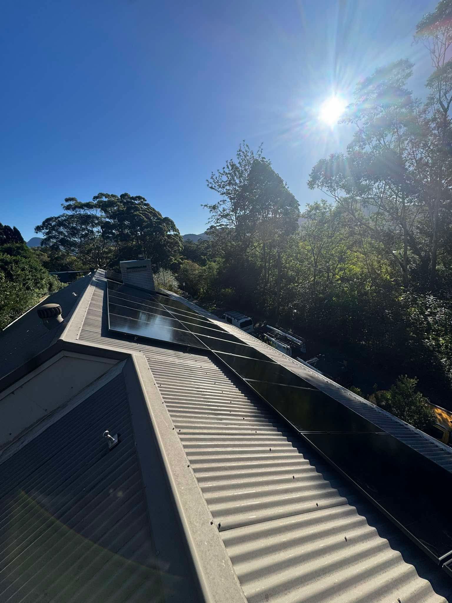 Sunlit Rooftop Walkway With Metal Railings — Rapidcool Air Conditioning & Electrical In Dapto, NSW