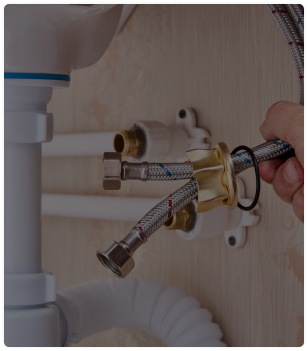 Plumber installing a new toilet in a bathroom
