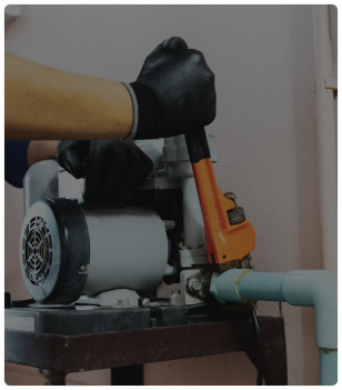 Plumber installing a sump pump in a basement