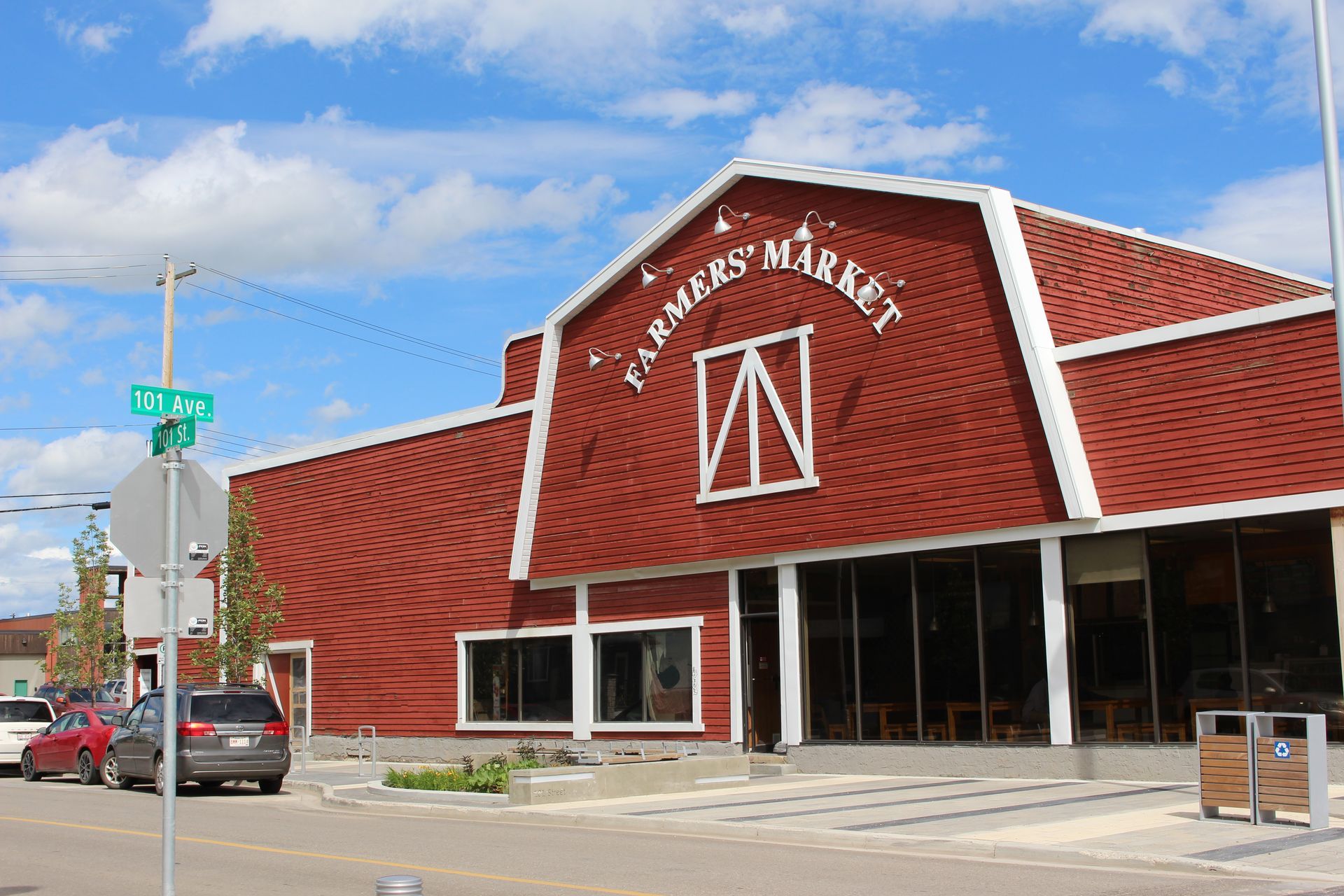 A red building with a sign that says farmers market