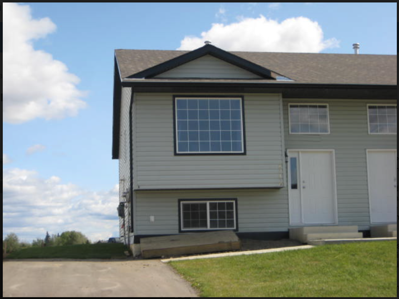 A house with a large window on the side of it