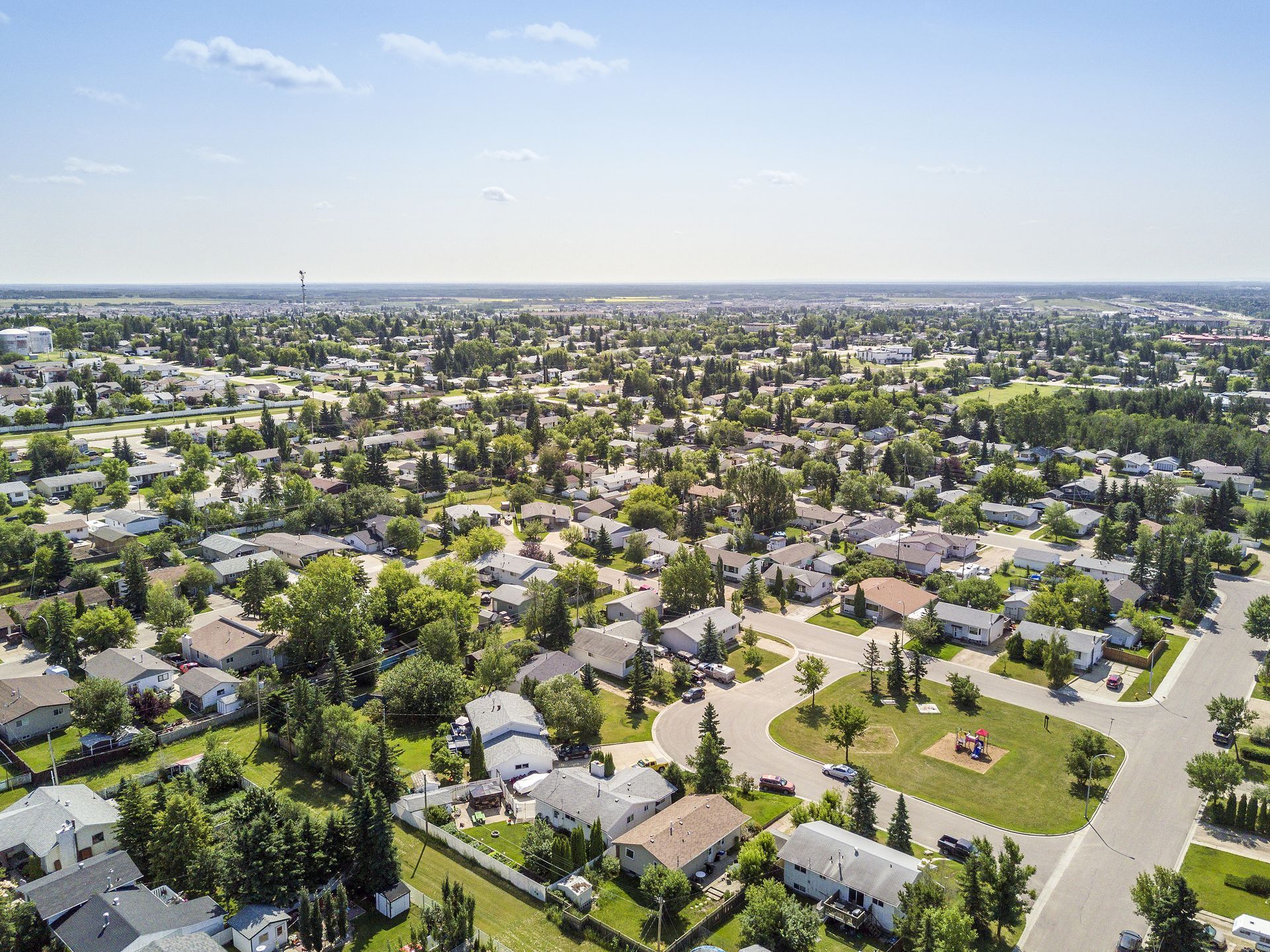 An aerial view of a residential area with lots of houses and trees.