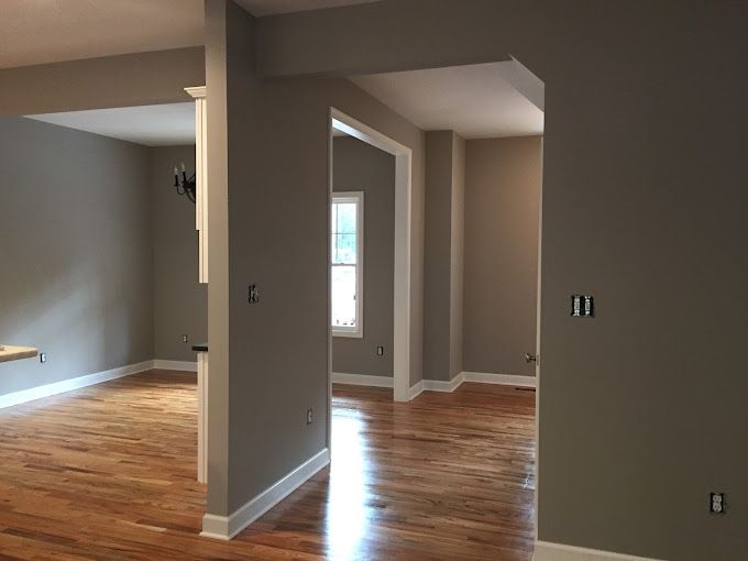 A living room with hardwood floors and gray walls.